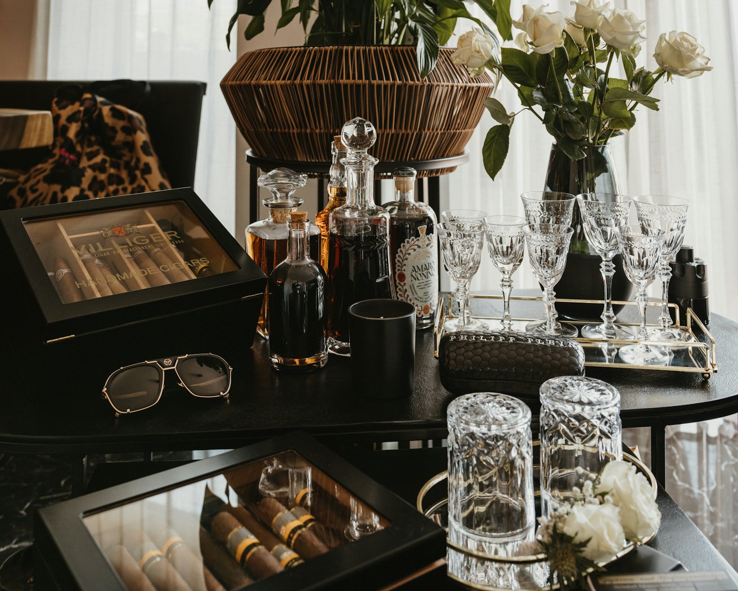 Luxury spirits and cigars displayed on a gold tray.